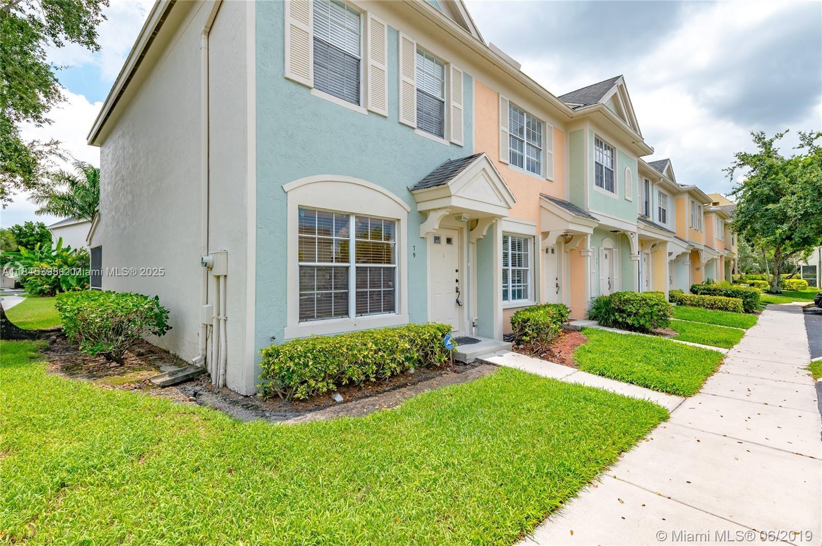 69 Simonton Circle, Unit 1 Weston, FL 33326 - Photo 1 of 23 a view of a brick house with a yard and plants
