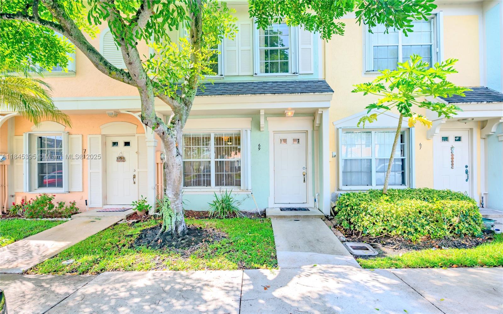 69 Simonton Circle, Unit 1 Weston, FL 33326 - Photo 15 of 23 a front view of a house with garden