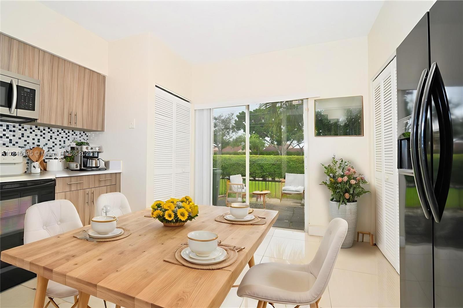 69 Simonton Circle, Unit 1 Weston, FL 33326 - Photo 4 of 23 a view of a dining room with furniture a potted plant and a table