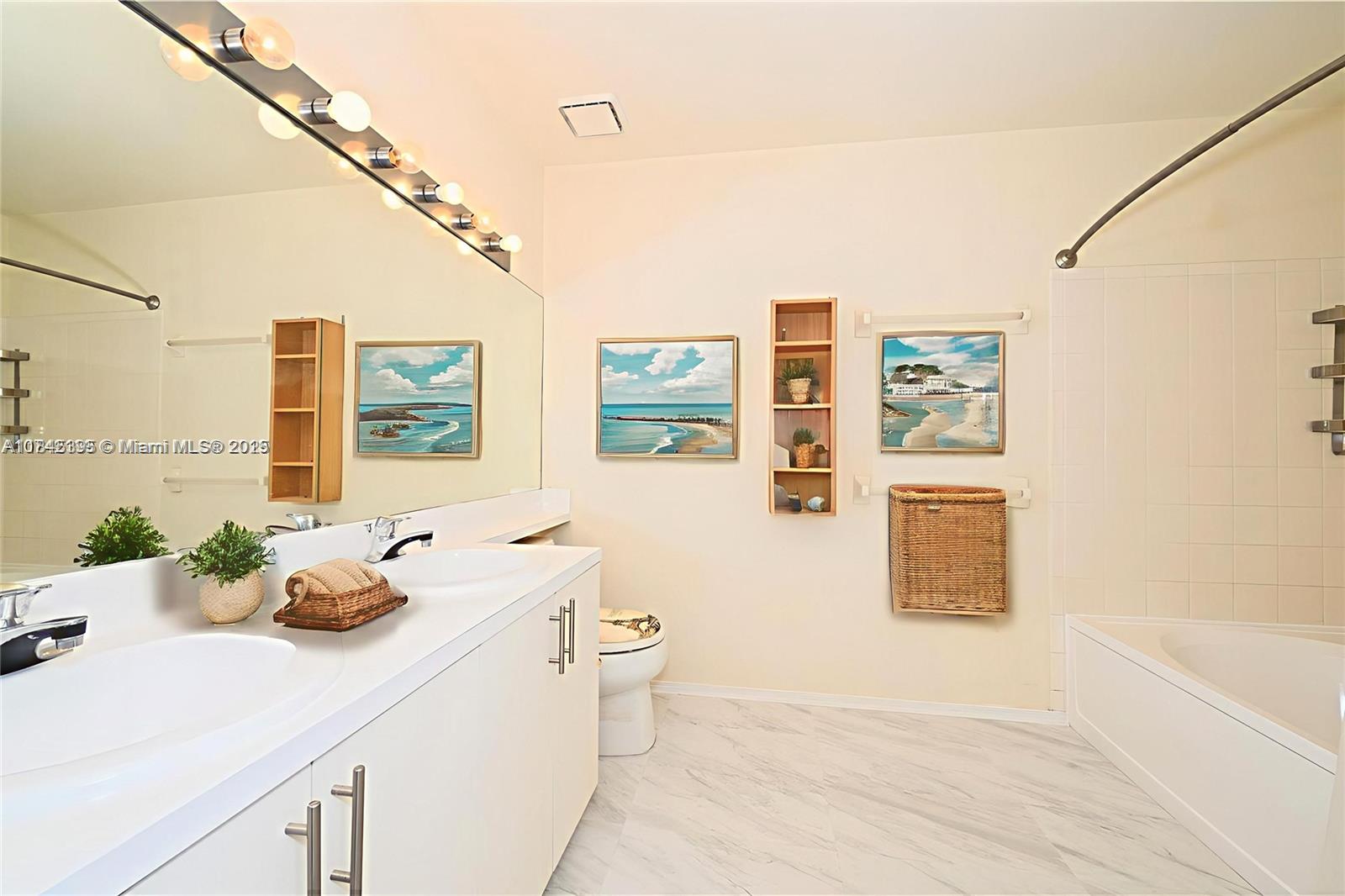 69 Simonton Circle, Unit 1 Weston, FL 33326 - Photo 7 of 23 a bathroom with a granite countertop sink a large mirror and shower