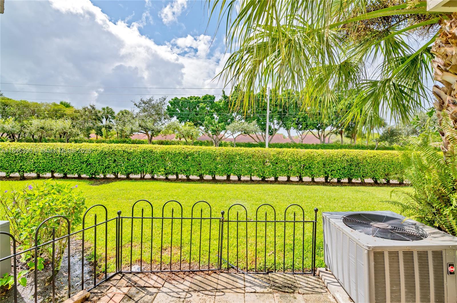 69 Simonton Circle, Unit 1 Weston, FL 33326 - Photo 10 of 23 a view of a swimming pool with a garden