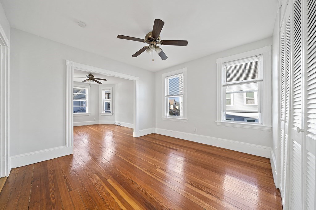 7 Tolman Street, Unit 2 Boston, MA 02122 - Photo 5 of 13 a view of empty room with wooden floor and ceiling fan