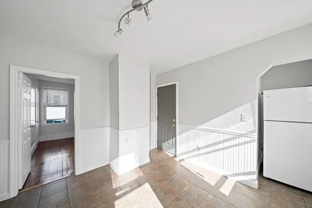 a view of a hallway with an entryway and livingroom