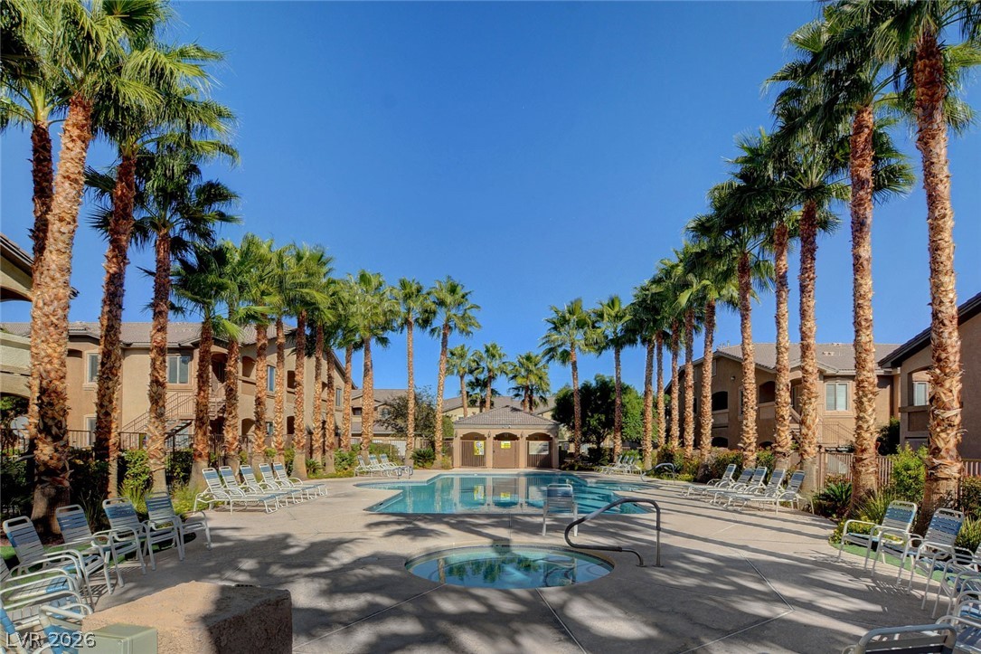 8985 South Durango Drive, Unit 2187 Las Vegas, NV 89113 - Photo 72 of 73 Palm-lined oasis surrounds a refreshing pool and inviting hot tub.