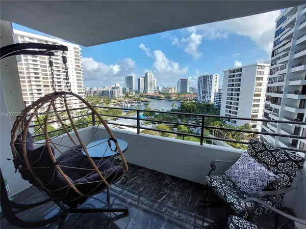 a view of a chairs and table in the balcony