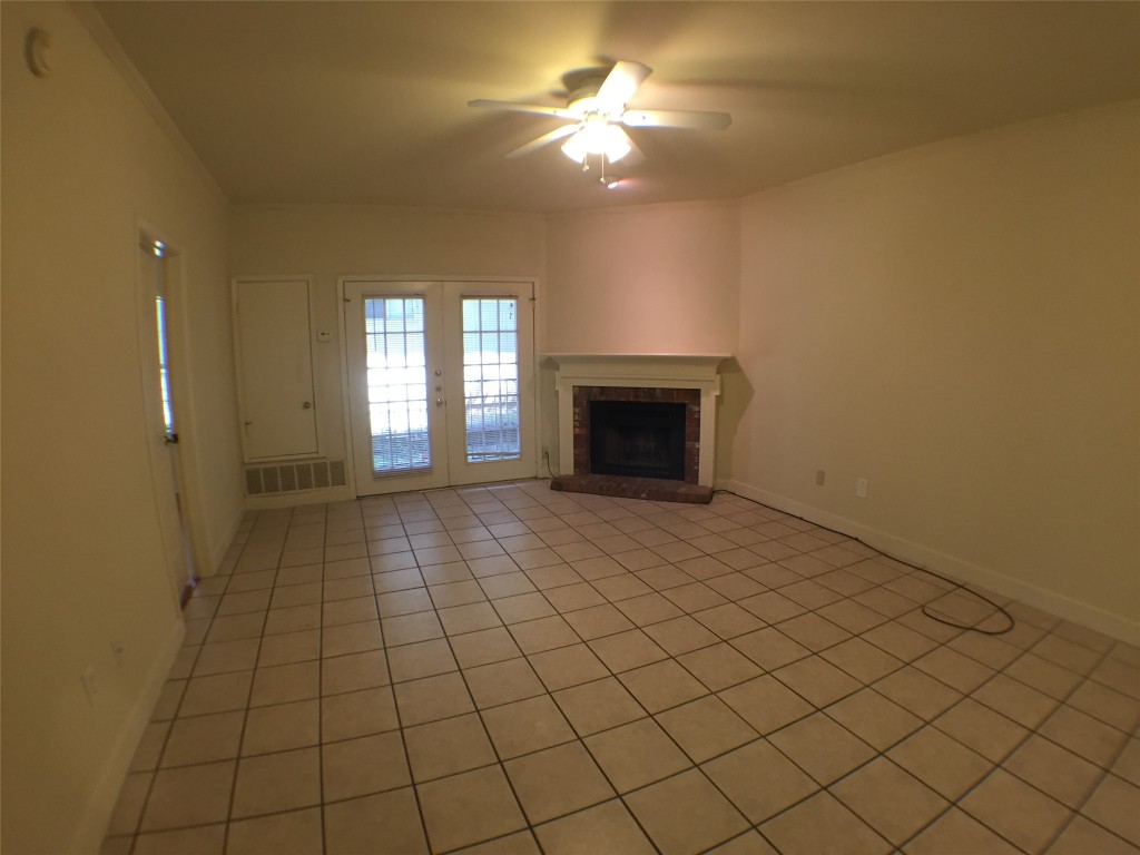 2100 San Gabriel Street, Unit 103 Austin, TX 78705 - Photo 11 of 20 an empty room with windows and fireplace