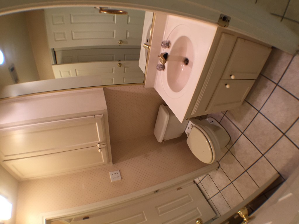 2100 San Gabriel Street, Unit 103 Austin, TX 78705 - Photo 12 of 20 a bathroom with a sink toilet and vanity