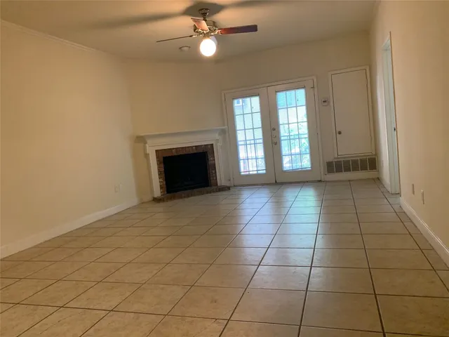 a spacious bathroom with a granite countertop sink a mirror and a toilet