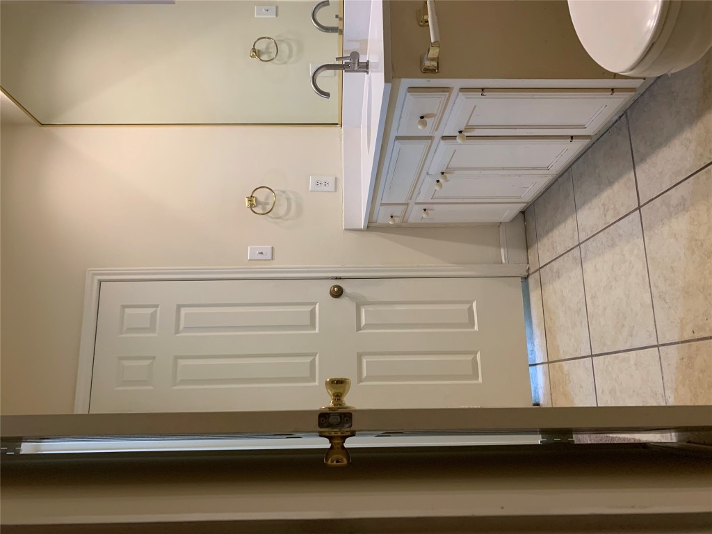 2100 San Gabriel Street, Unit 103 Austin, TX 78705 - Photo 16 of 20 a spacious bathroom with a granite countertop sink a mirror and a toilet