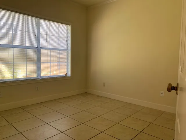 a view of a livingroom with an empty space and a window