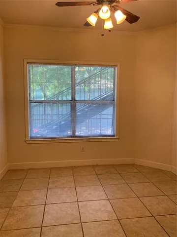 a view of an empty room and a window