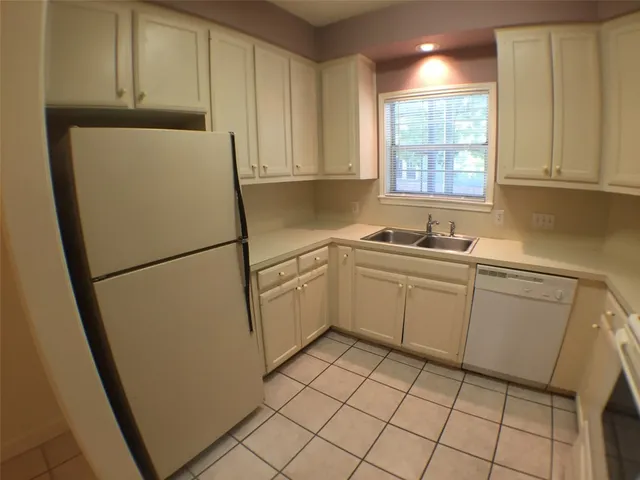 a utility room with cabinets washer and dryer