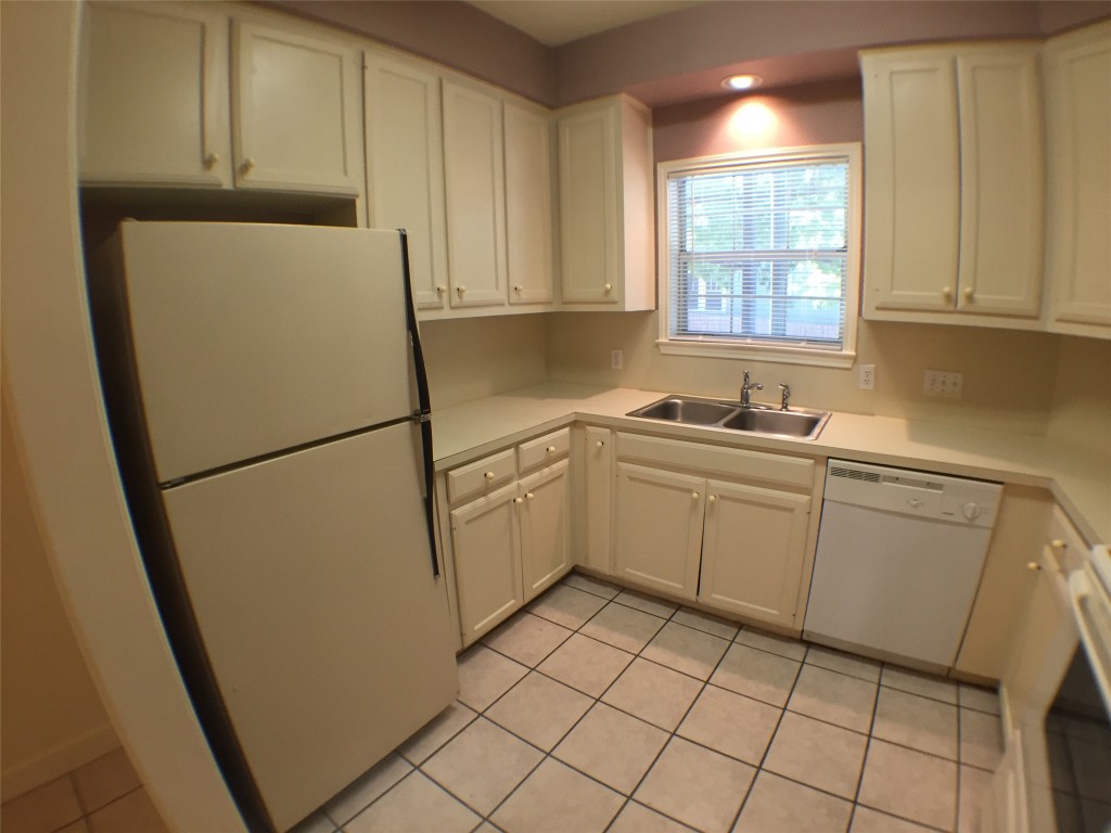2100 San Gabriel Street, Unit 103 Austin, TX 78705 - Photo 5 of 20 a utility room with cabinets washer and dryer