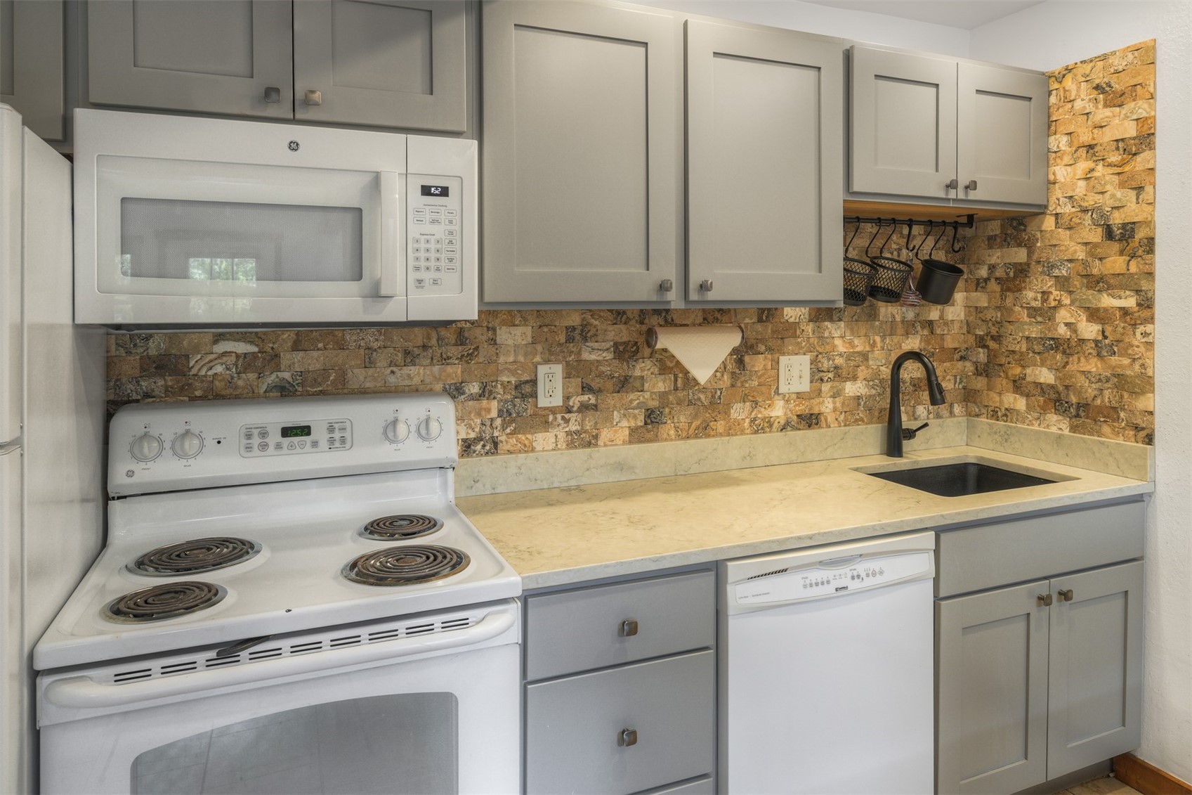 132 Illinois Gulch Road, Unit 3 Breckenridge, CO 80424 - Photo 6 of 32 a kitchen with a sink stove and cabinets