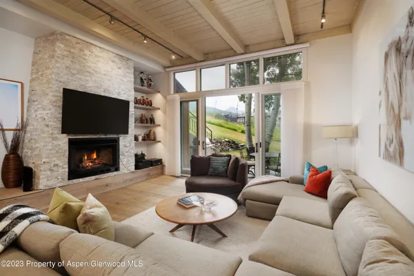 a living room with furniture and a fireplace