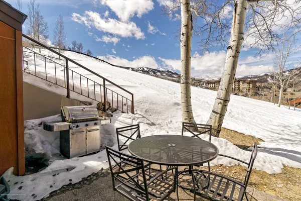 a view of a balcony with table and chairs