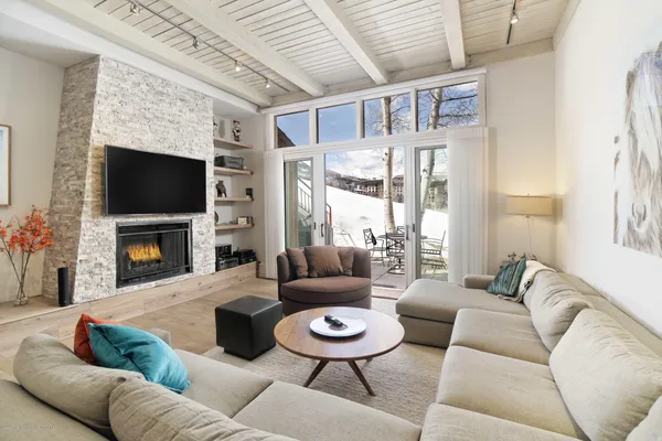 a living room with furniture a fireplace and a flat screen tv