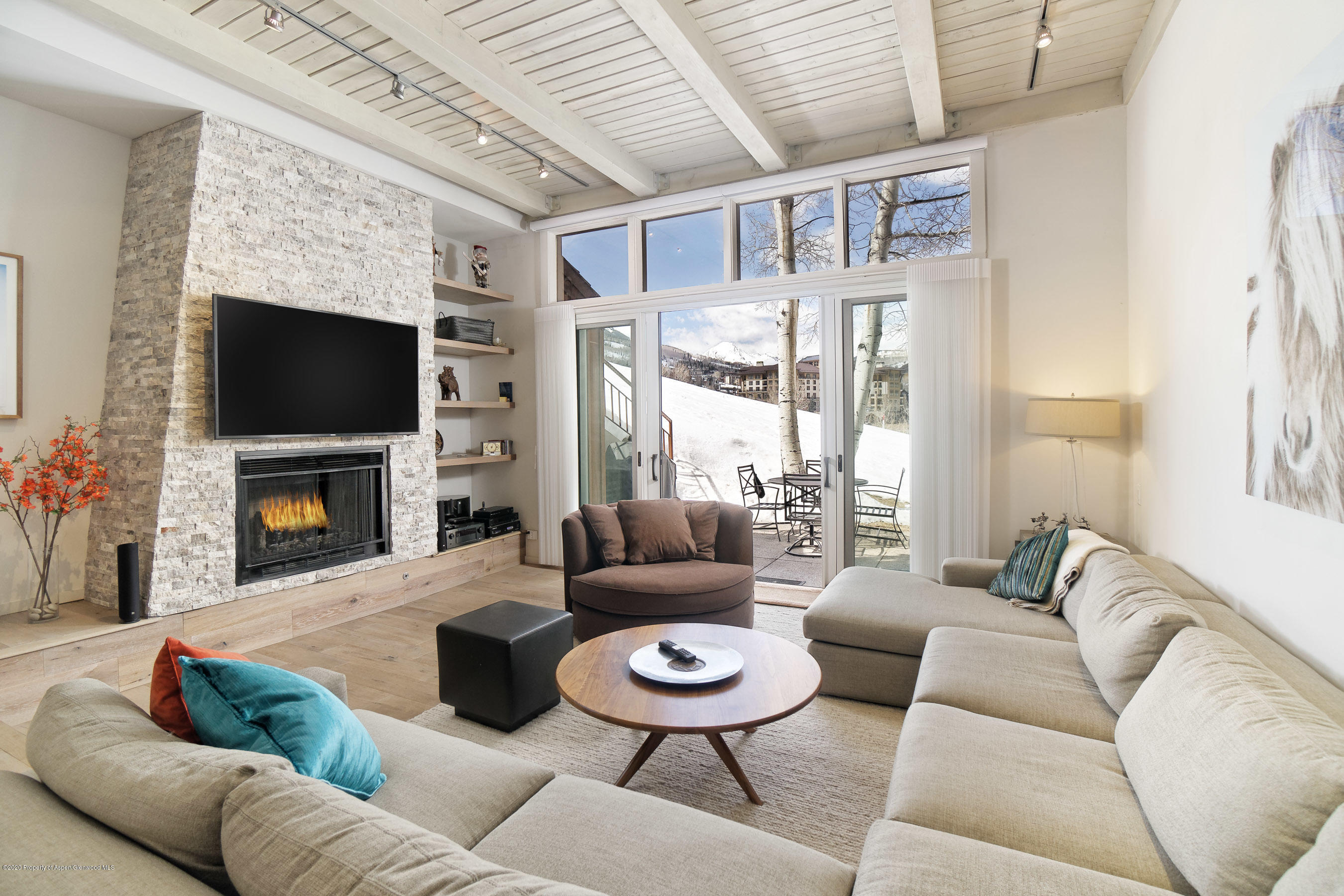 810 Ridge Road, Unit 6 Snowmass Village, CO 81615 - Photo 2 of 33 a living room with furniture a fireplace and a flat screen tv