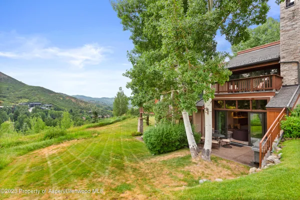 a view of a house with backyard porch and sitting area