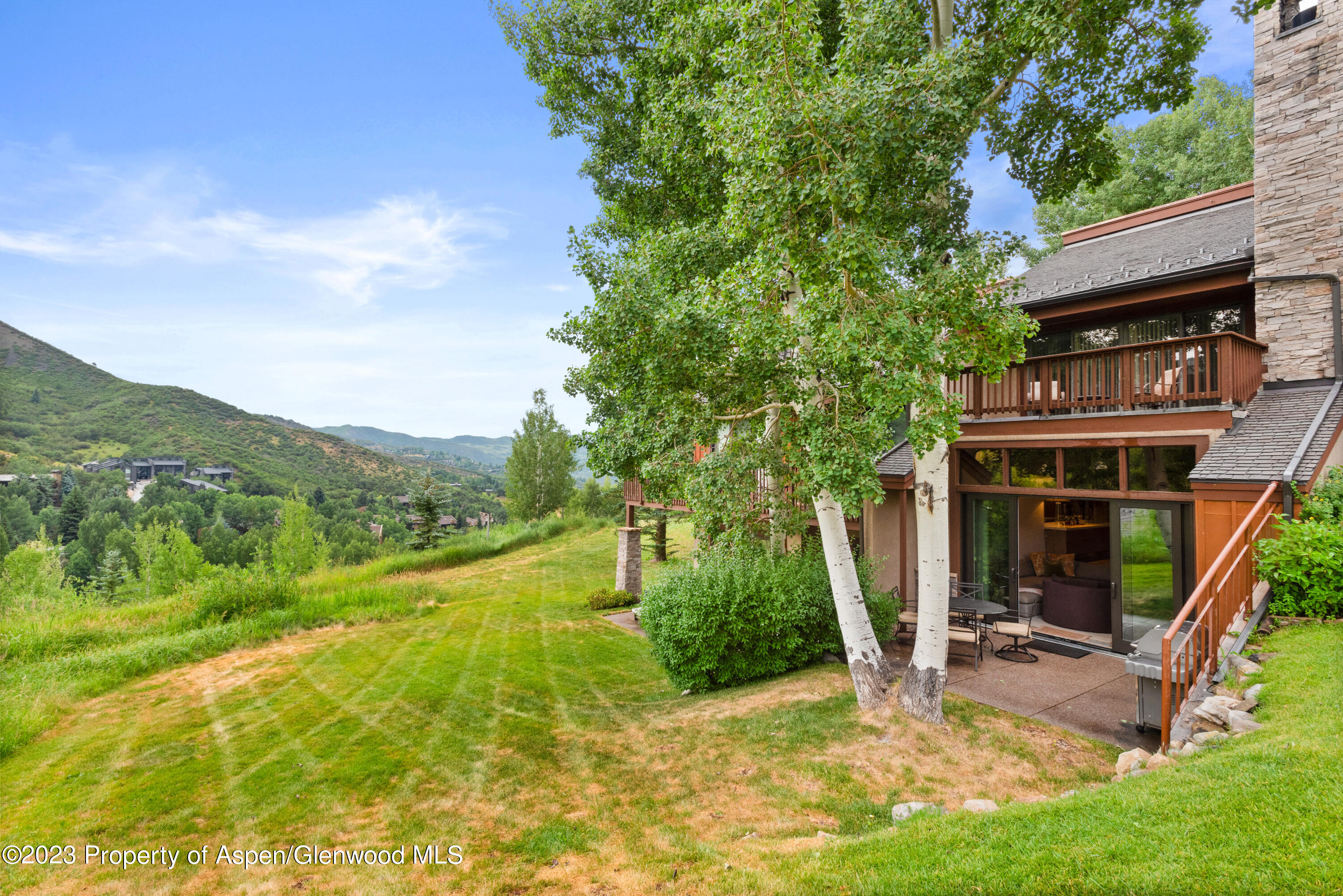 810 Ridge Road, Unit 6 Snowmass Village, CO 81615 - Photo 21 of 33 a view of a house with backyard porch and sitting area