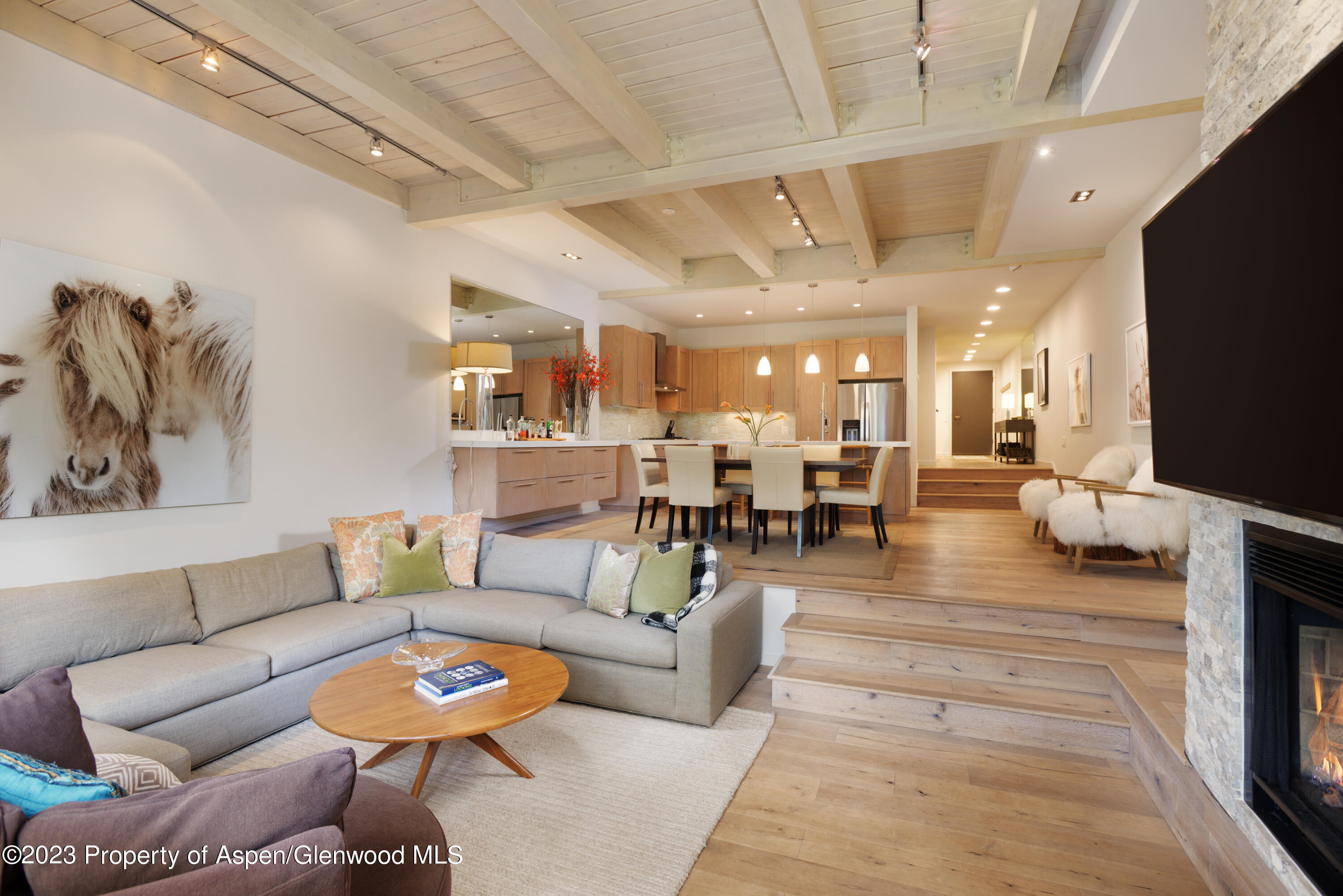 810 Ridge Road, Unit 6 Snowmass Village, CO 81615 - Photo 5 of 33 a living room with furniture kitchen view and a chandelier