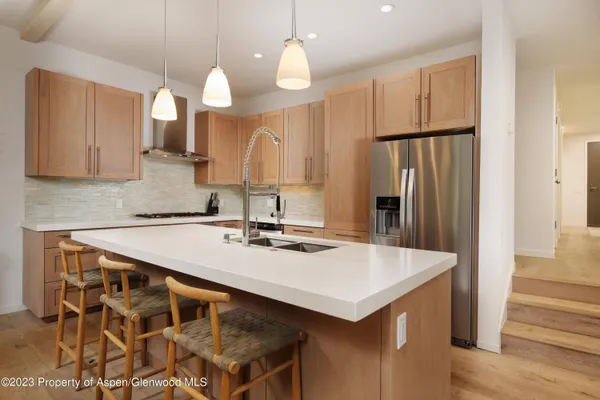 a kitchen with a sink a refrigerator and a stove