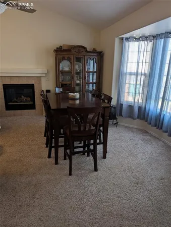 a view of a dining room with furniture and window