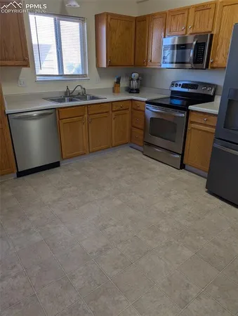 a kitchen with stainless steel appliances granite countertop a sink and a stove