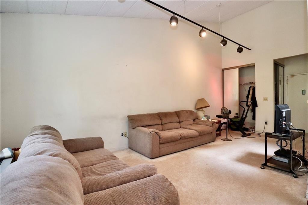 9967 Shore Road, Unit 7E Brooklyn, NY 11209 - Photo 13 of 19 a living room with furniture and a gym equipment