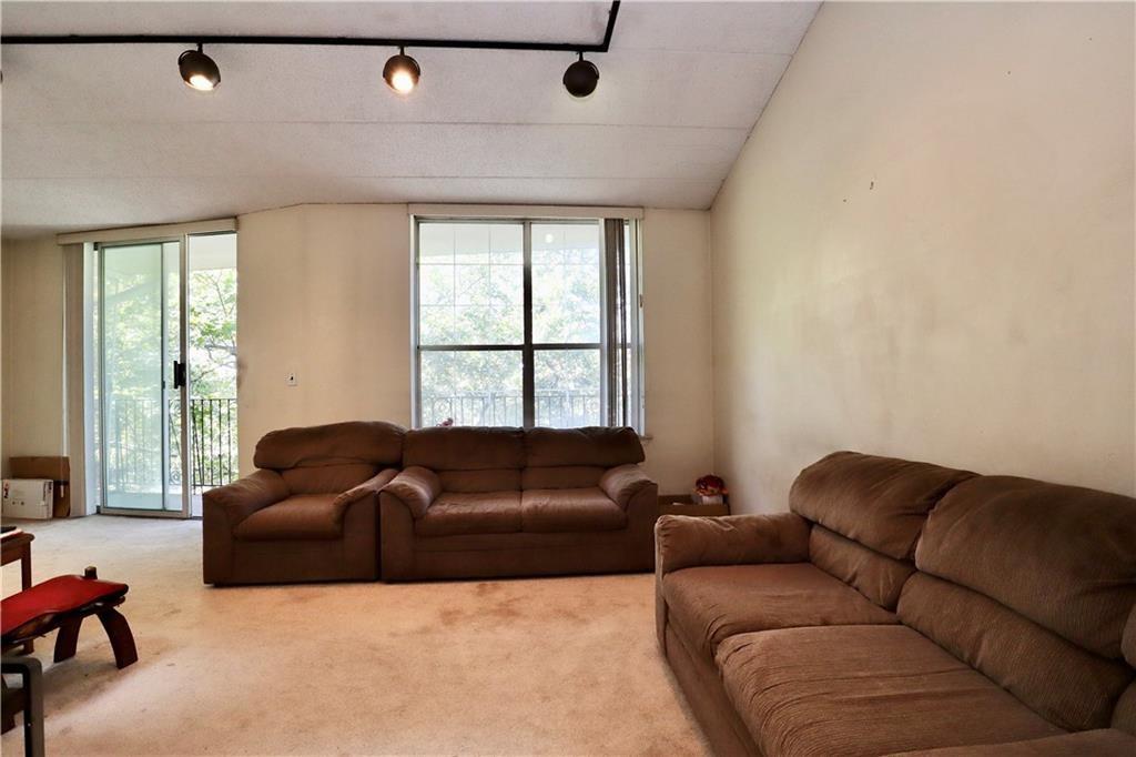 9967 Shore Road, Unit 7E Brooklyn, NY 11209 - Photo 14 of 19 a living room with furniture and a large window