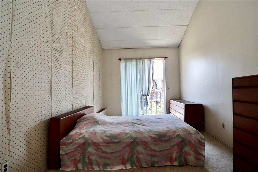 9967 Shore Road, Unit 7E Brooklyn, NY 11209 - Photo 6 of 19 a bedroom with a bed and wooden floor