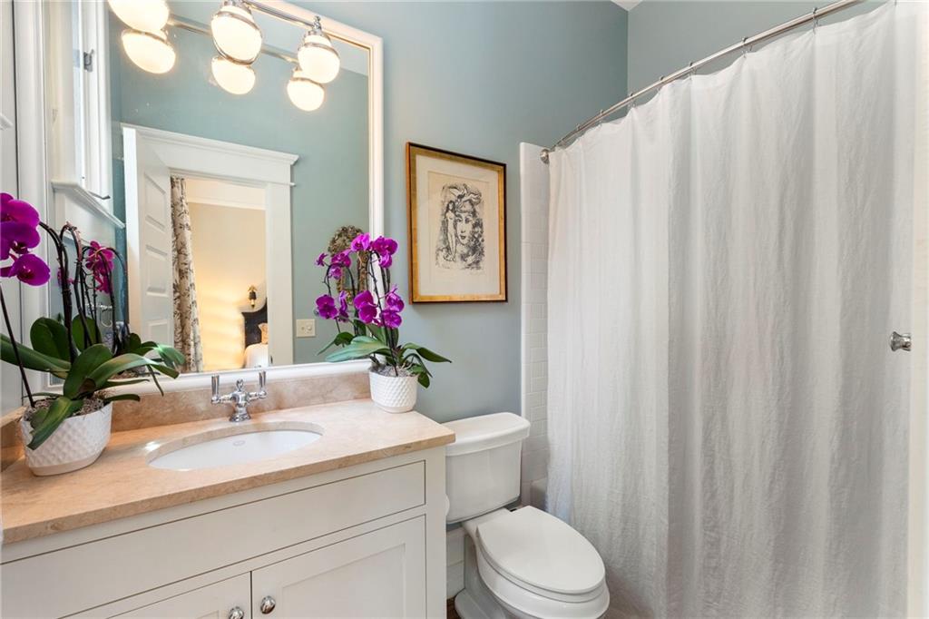 2519 Forrest Way Northeast Atlanta, GA 30305 - Photo 27 of 36 a bathroom with a sink a mirror and a toilet