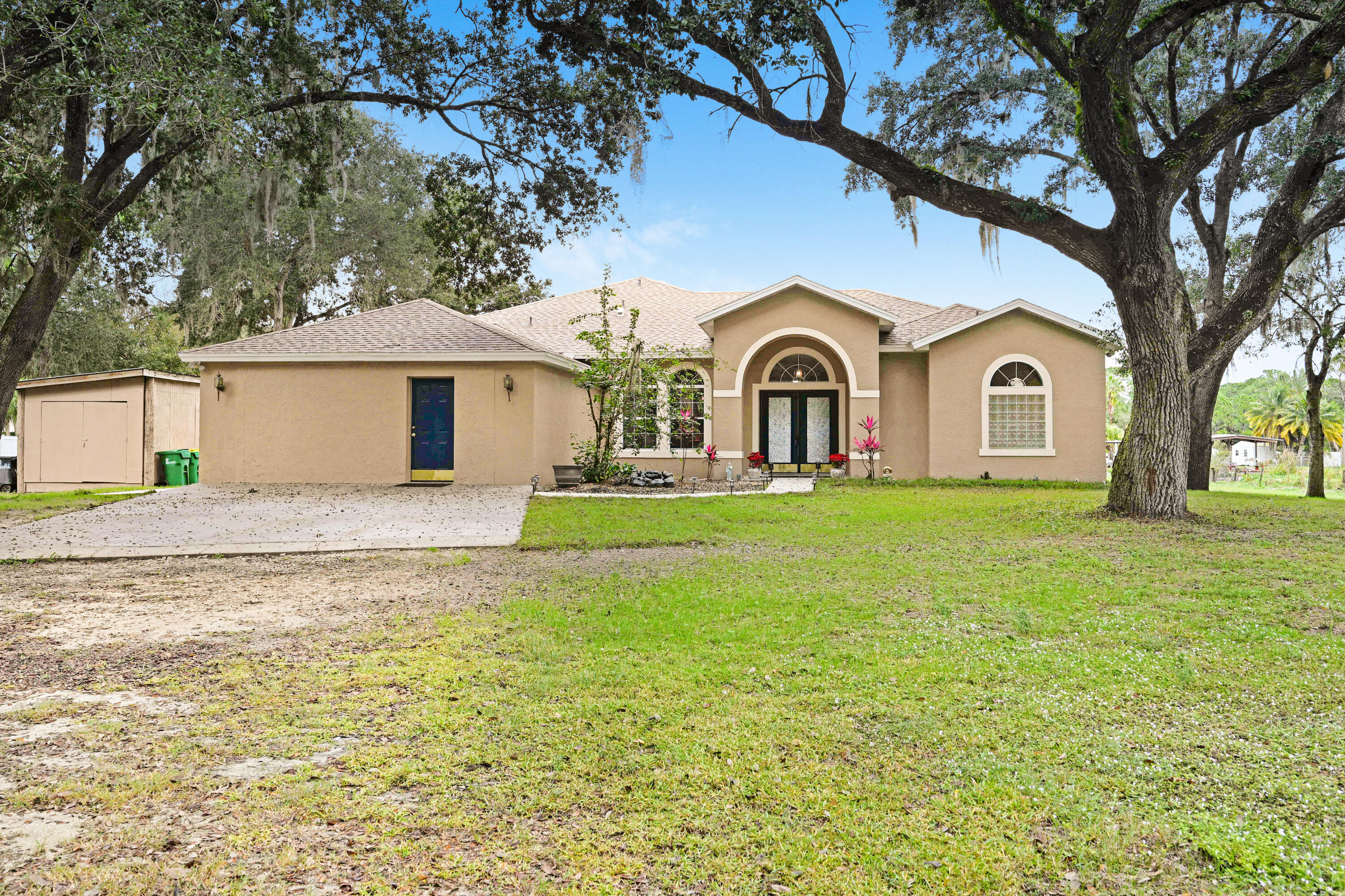 a front view of a house with yard and green space
