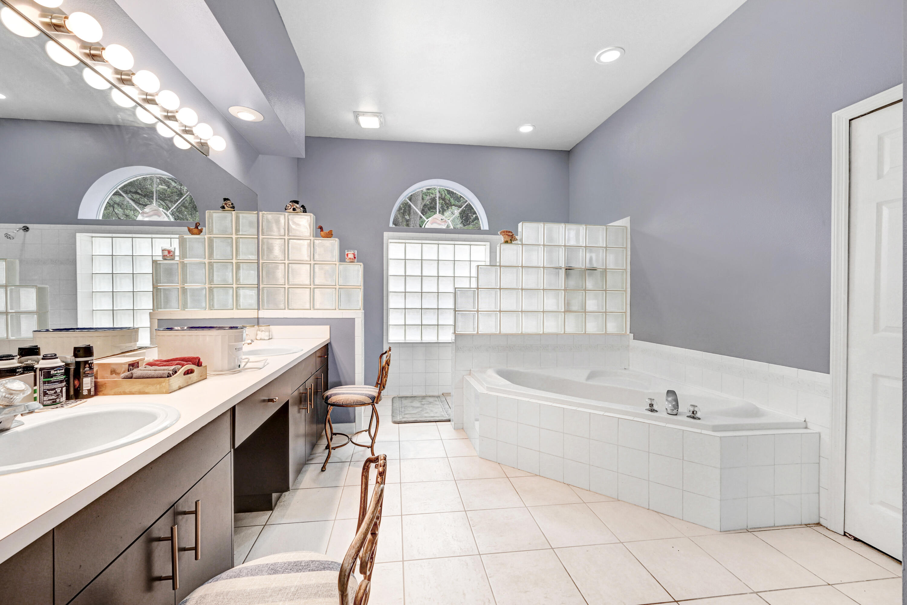 4600 James Road Cocoa, FL 32926 - Photo 13 of 56 a bathroom with a sink a large mirror and a bathtub next to a window