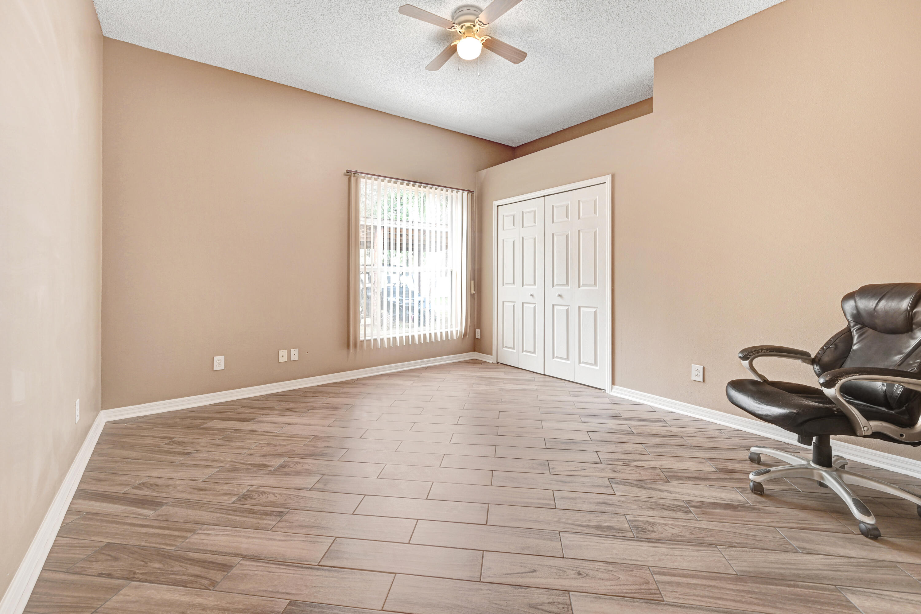 4600 James Road Cocoa, FL 32926 - Photo 19 of 56 a view of an empty room with a window and wooden floor