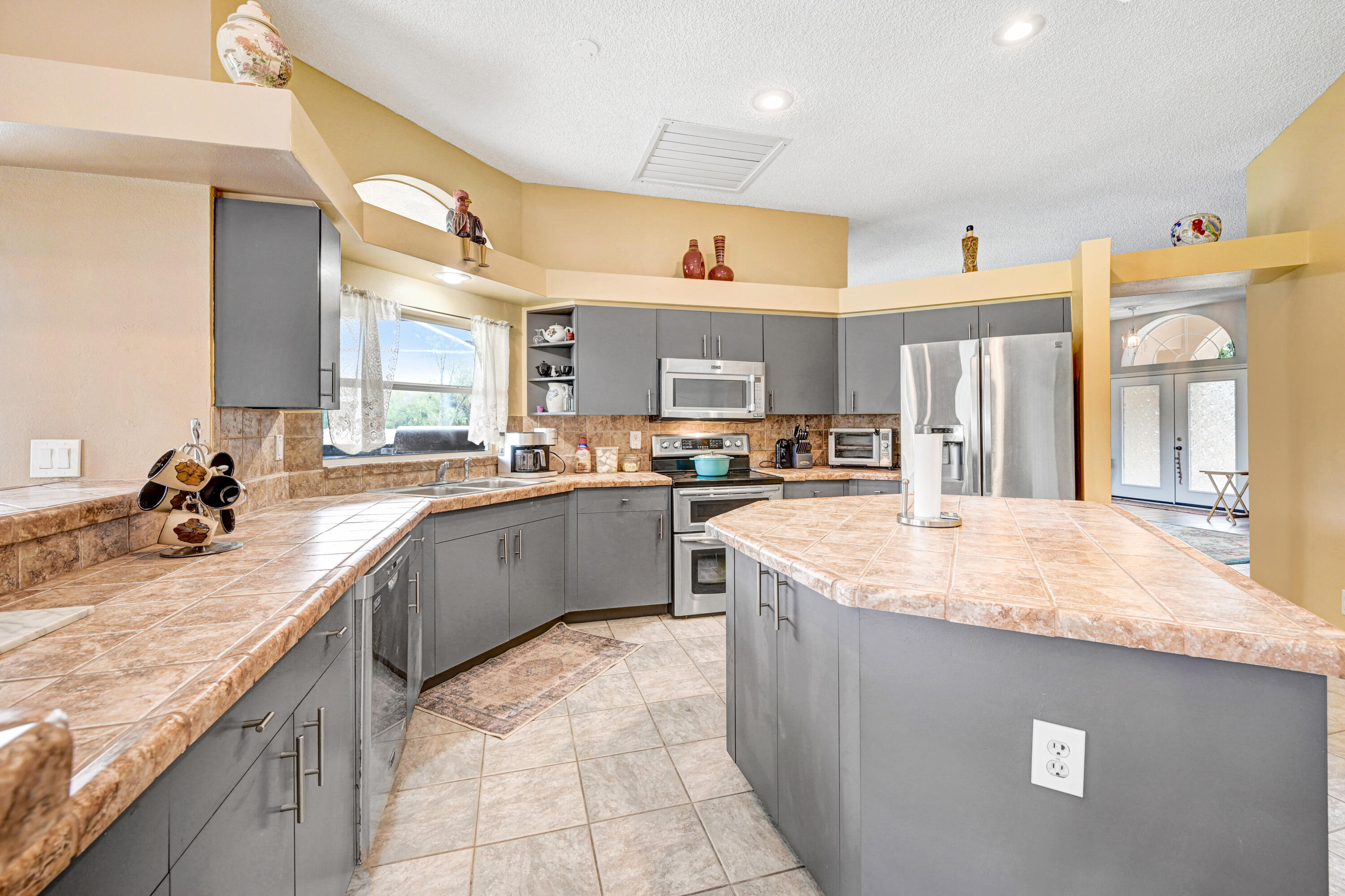 4600 James Road Cocoa, FL 32926 - Photo 21 of 56 a kitchen with stainless steel appliances granite countertop a sink counter space cabinets and a large window