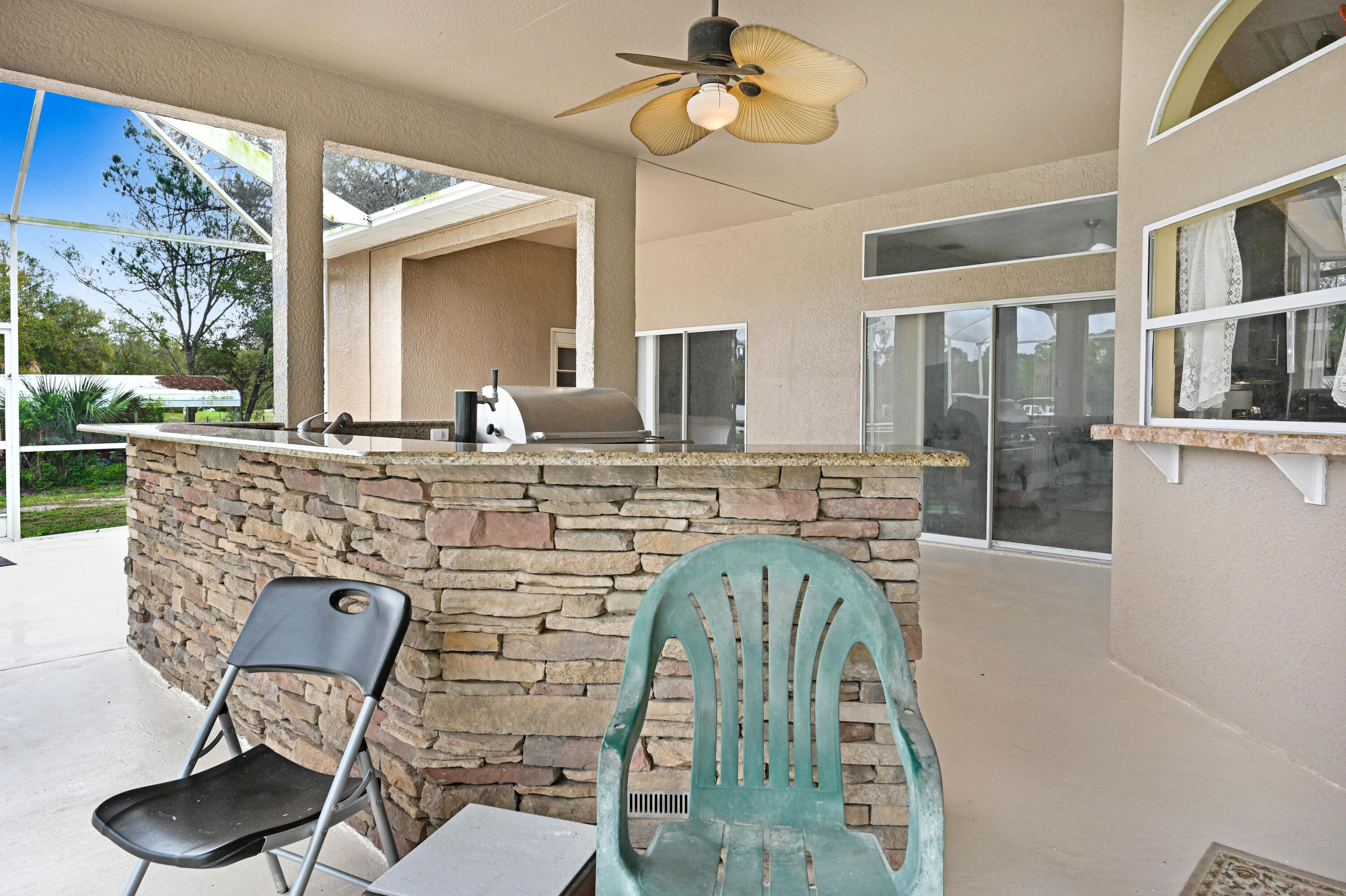 4600 James Road Cocoa, FL 32926 - Photo 37 of 56 a living room with a couch and a floor to ceiling window