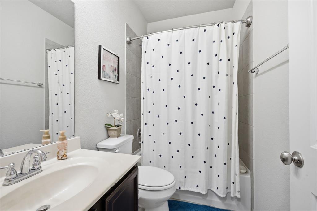 3728 Evergreen Ridge Road Fort Worth, TX 76244 - Photo 8 of 21 Full bathroom featuring a single vanity with an integrated sink, a toilet, and a tiled shower/tub combination