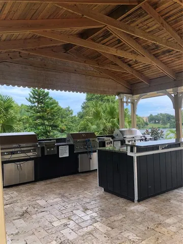 a view of a backyard with couches chairs and wooden floor