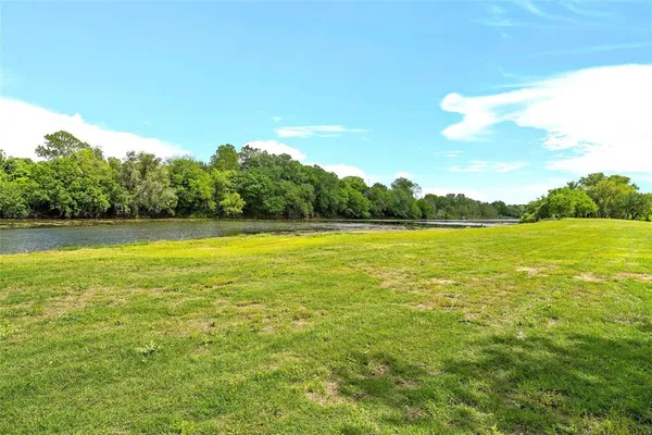 an aerial view of residential houses with outdoor space and trees
