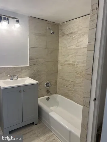 a kitchen with granite countertop a refrigerator and a sink