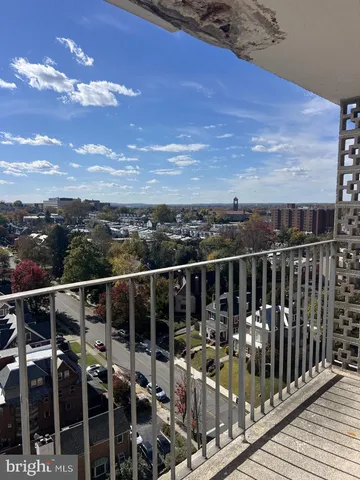 a view of a room with wooden floor and windows