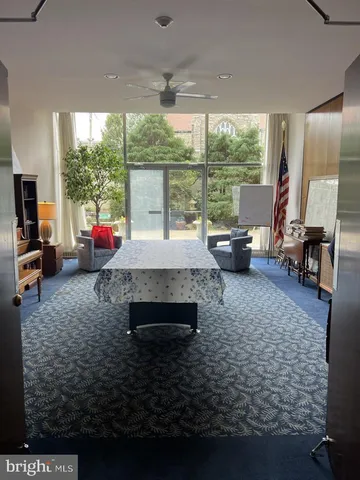 a living room with furniture and large windows