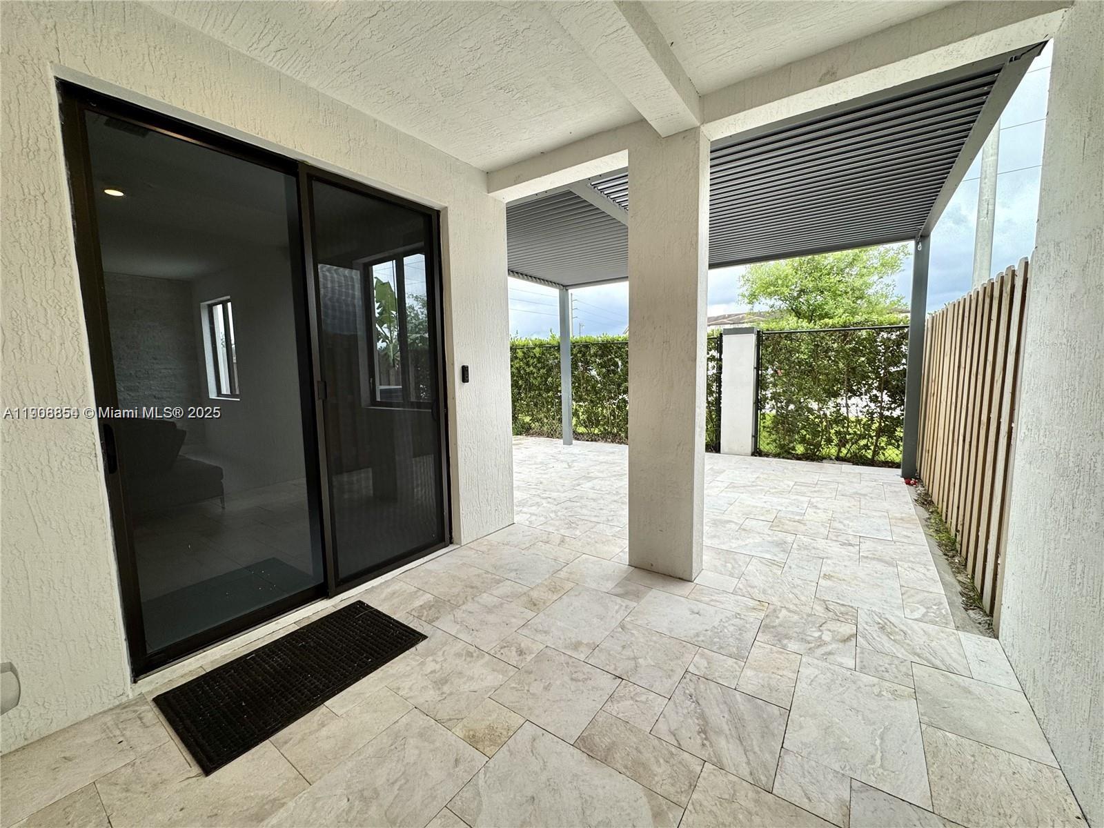 13627 Southwest 157th Court Miami, FL 33196 - Photo 11 of 26 a view of a porch
