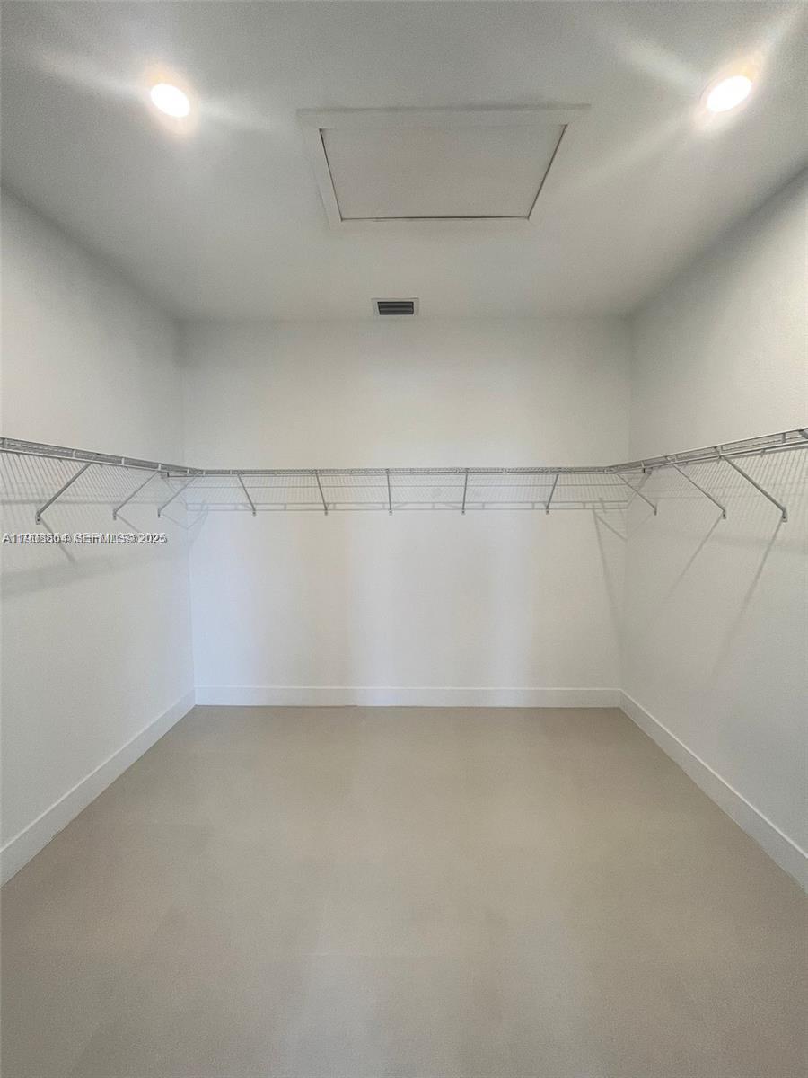 13627 Southwest 157th Court Miami, FL 33196 - Photo 19 of 26 a view of a room with racks on the wall