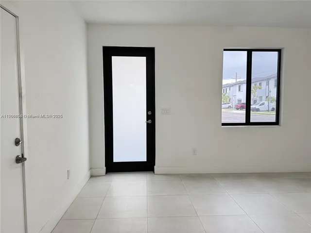 an empty room with windows and closet