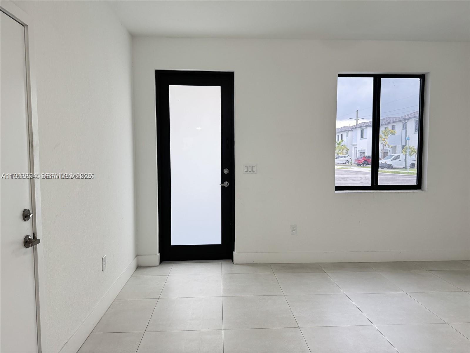13627 Southwest 157th Court Miami, FL 33196 - Photo 2 of 26 an empty room with windows and closet
