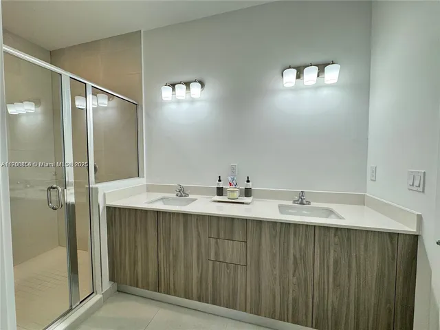 a bathroom with a shower and a sink