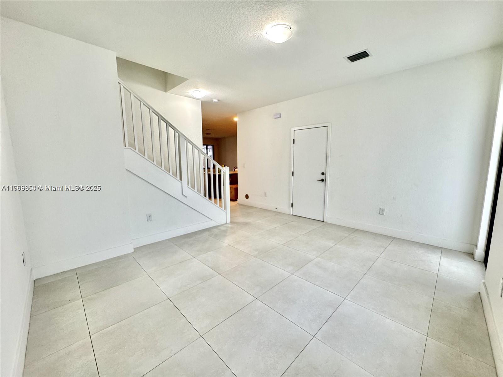13627 Southwest 157th Court Miami, FL 33196 - Photo 3 of 26 a view of a hallway with a hallway