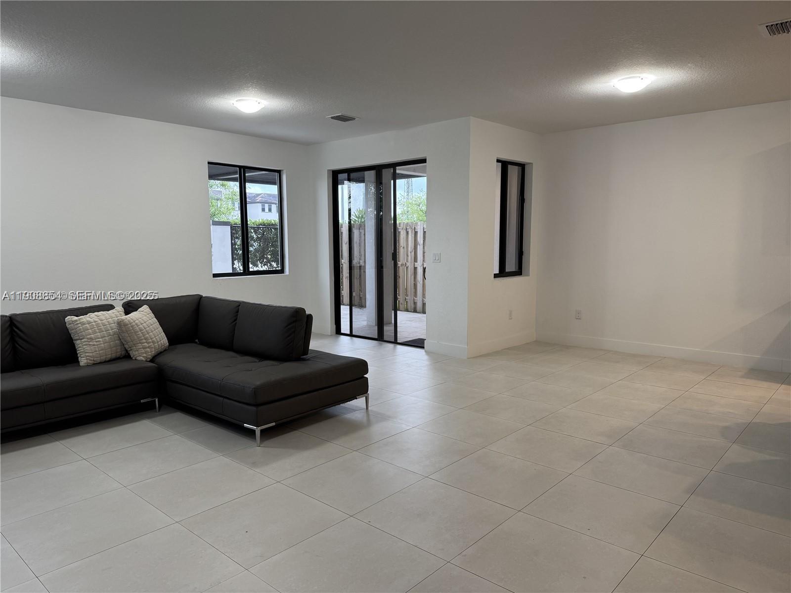 13627 Southwest 157th Court Miami, FL 33196 - Photo 6 of 26 a living room with furniture and a window